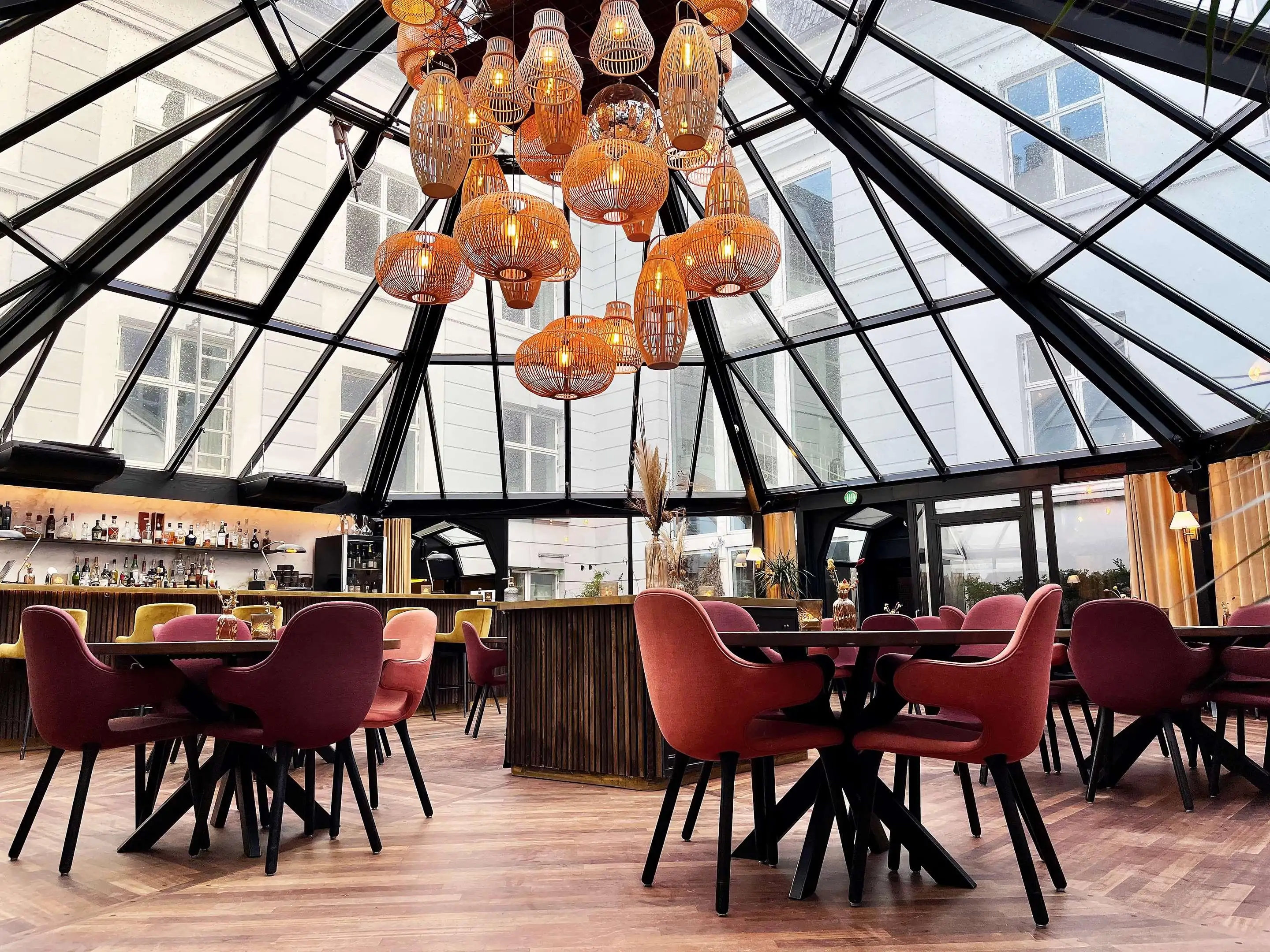 Restaurant with glass wintergarden and sculptural modern chandelier