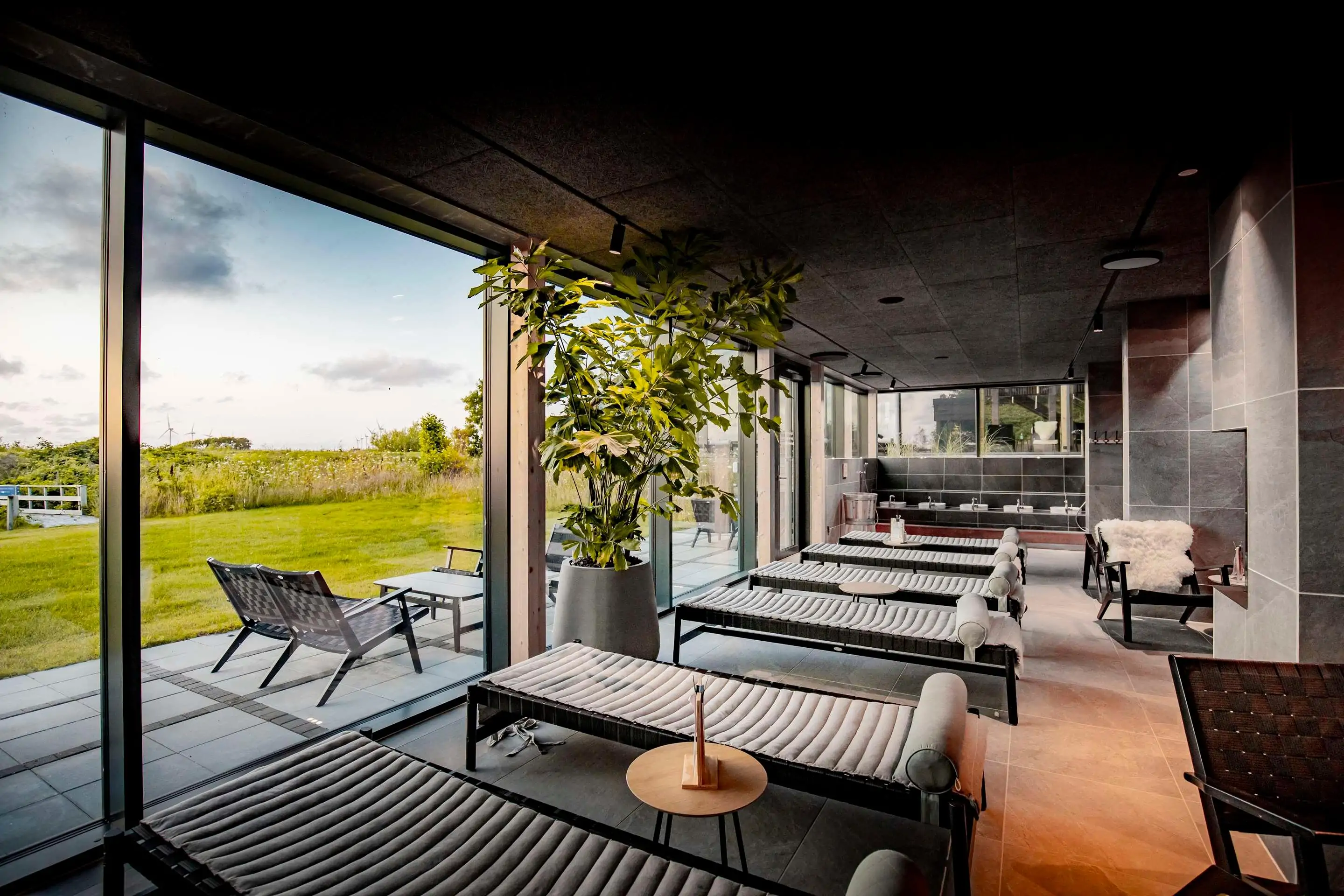 Rest room in a spa with large windows and view into the countryside