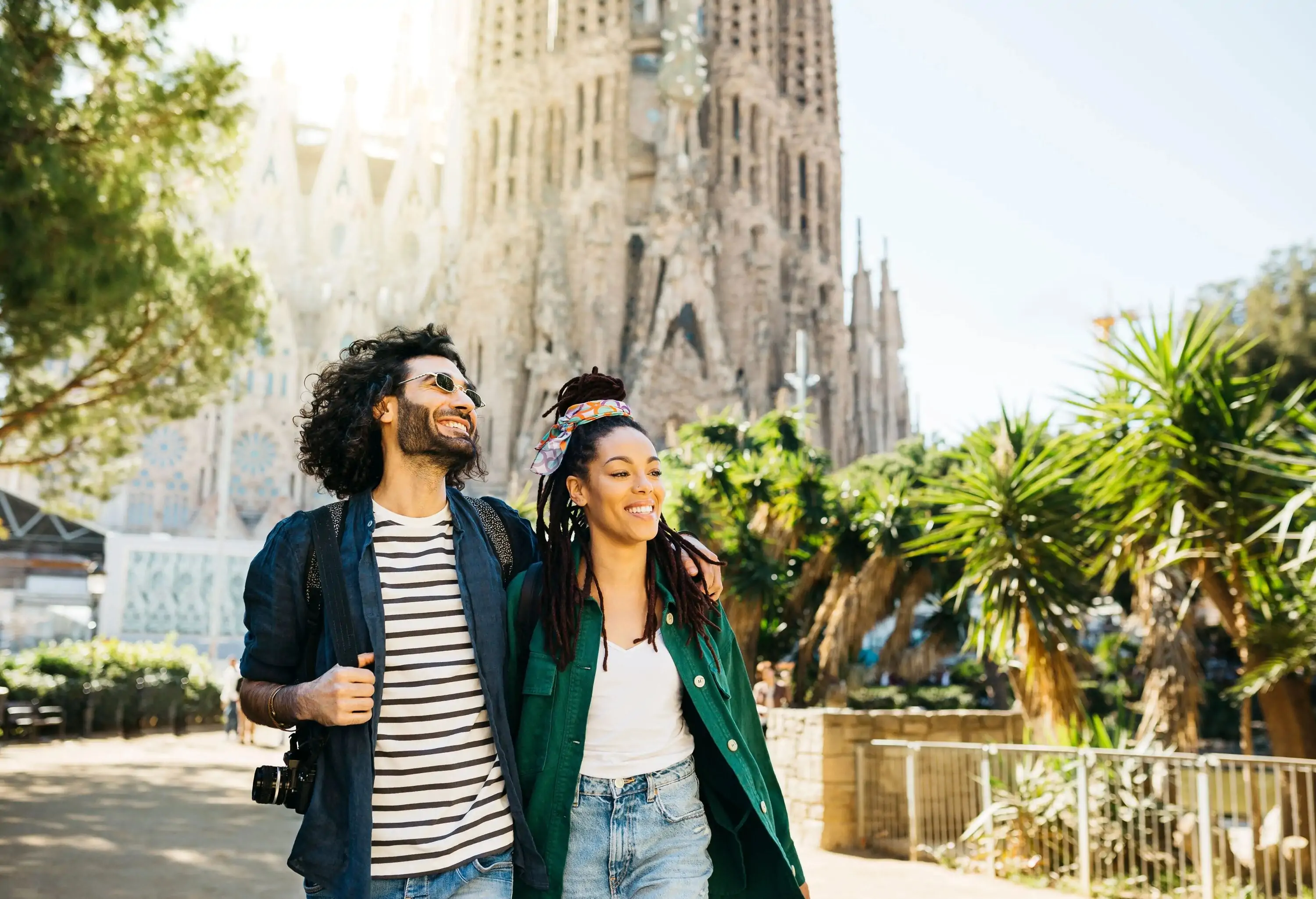 Smiling couple walking around Sagrada Familia church at Barcelona, Catalonia, Spain