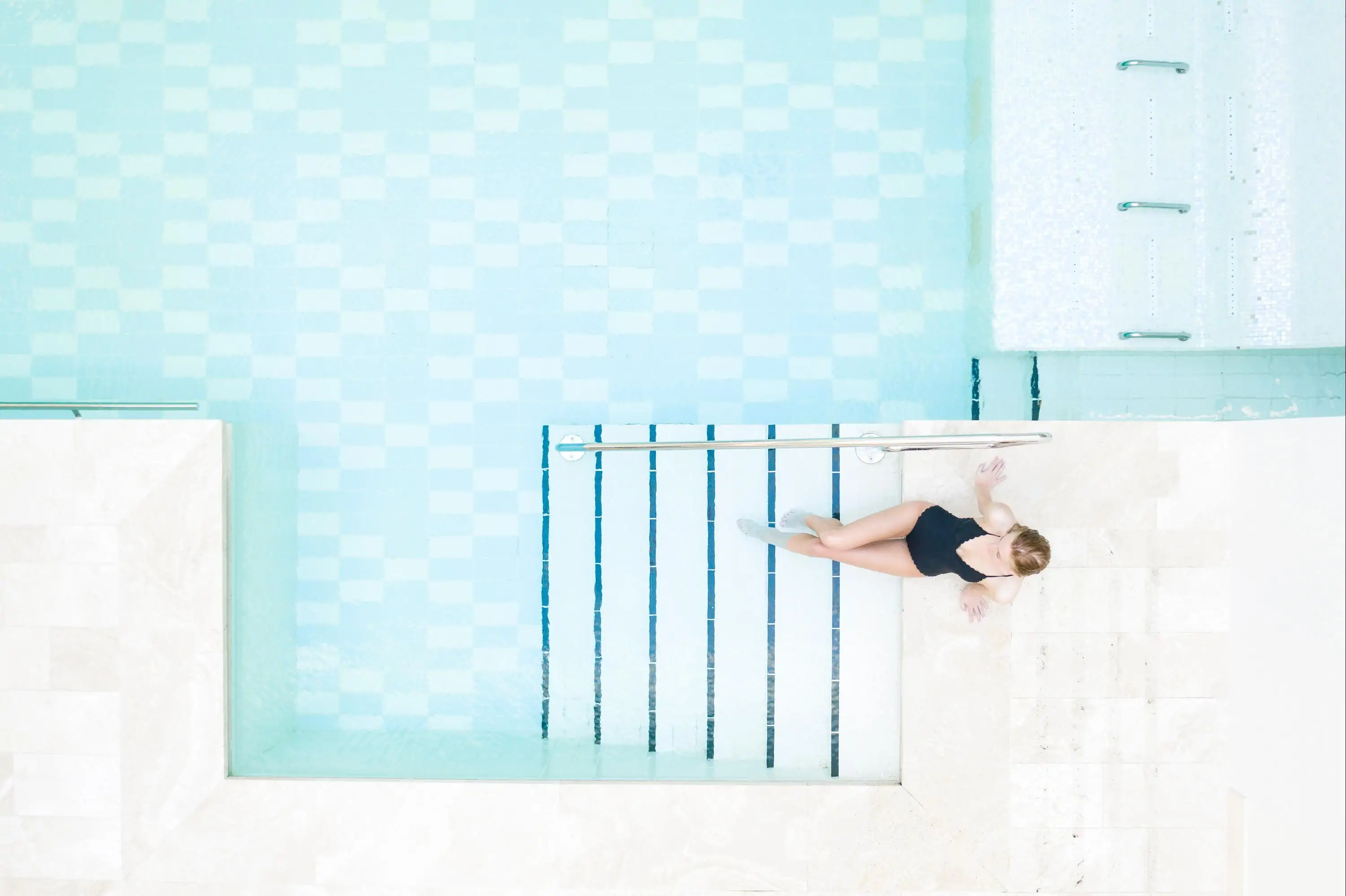 View from above of woman sitting inside spa pool