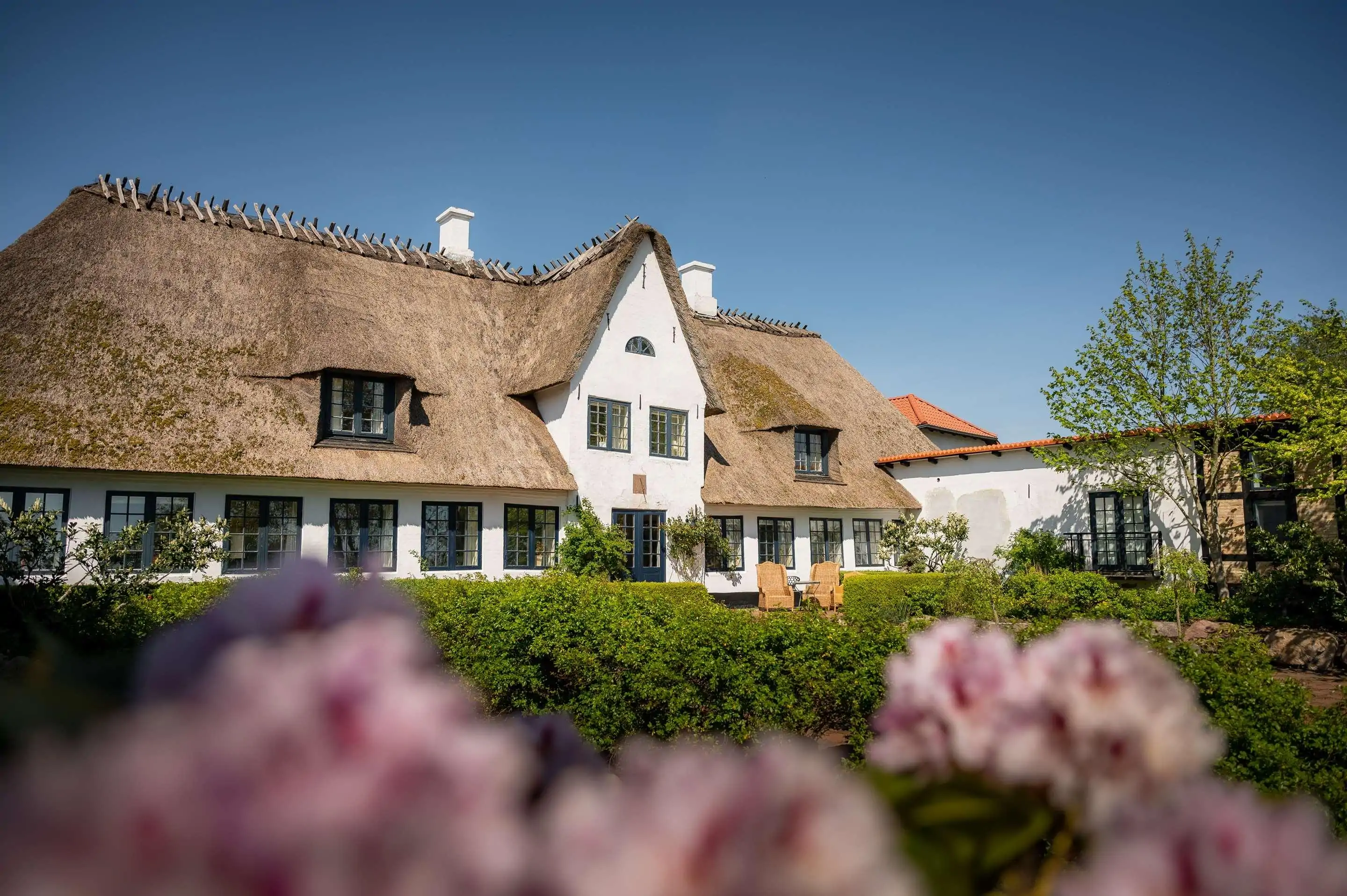 White hotel building with thatched room