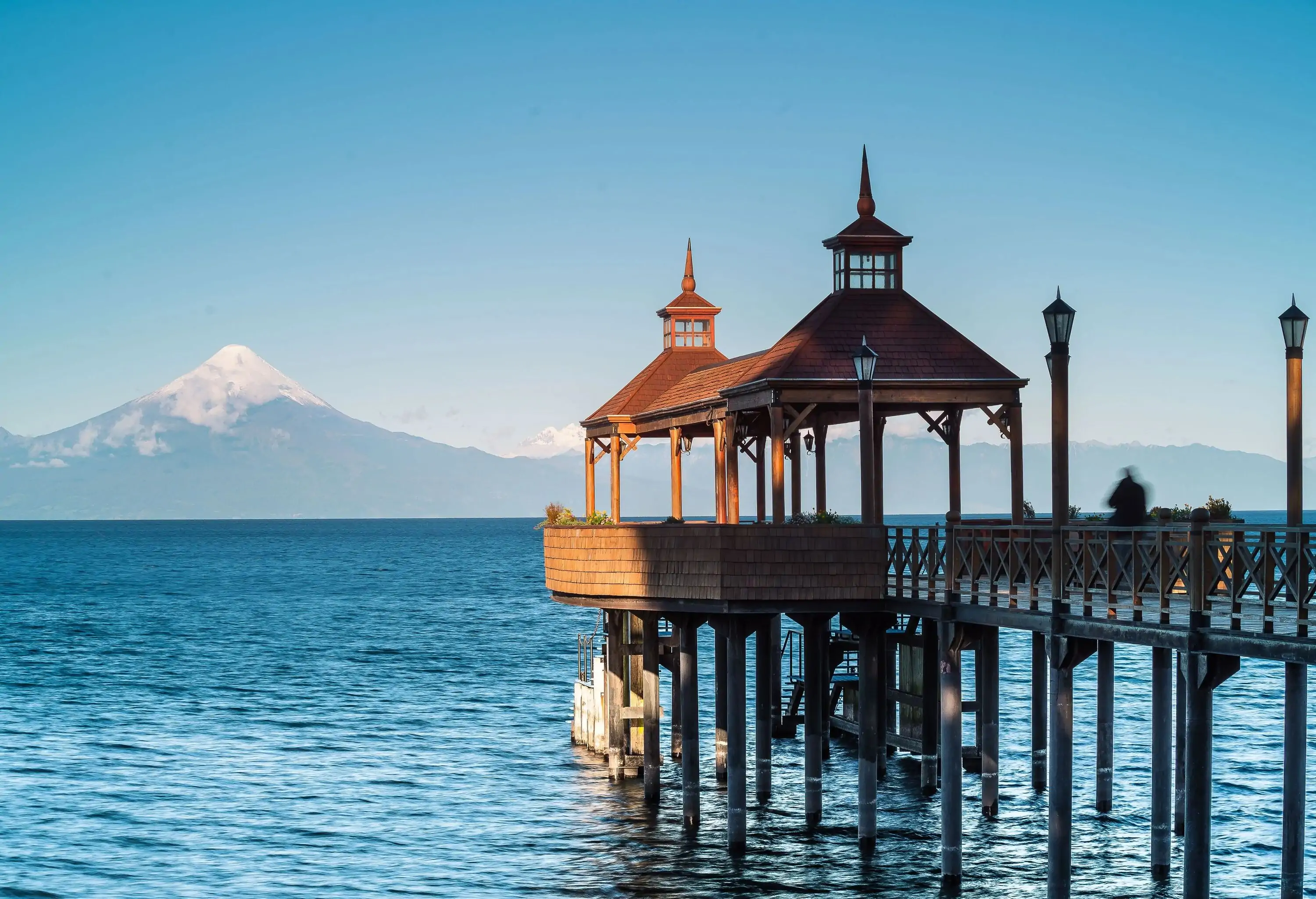 A covered jetty port of the lake overlooking the snow-capped volcano.