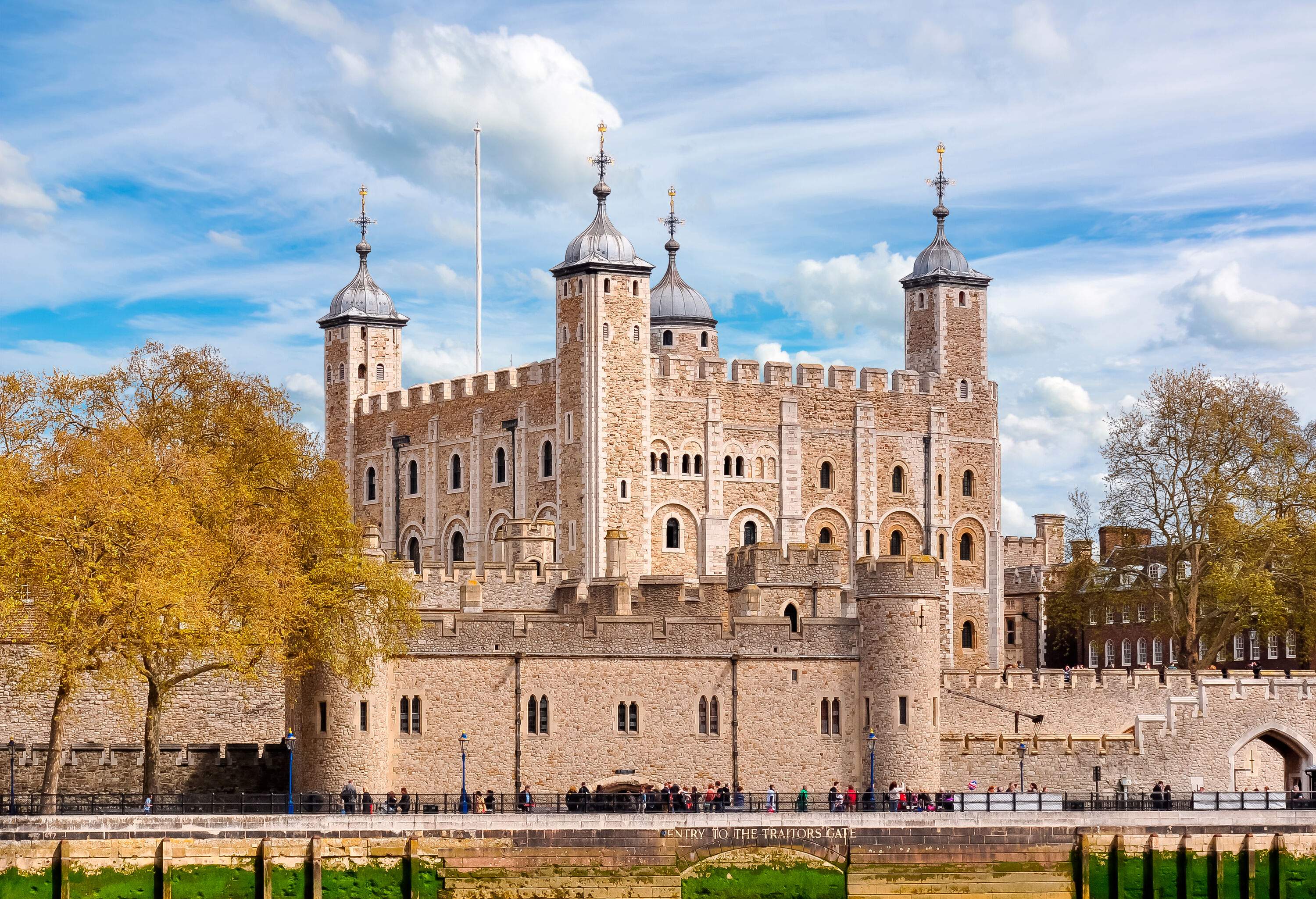 The Tower of London castle with people along the Traitor's Gate entrance.