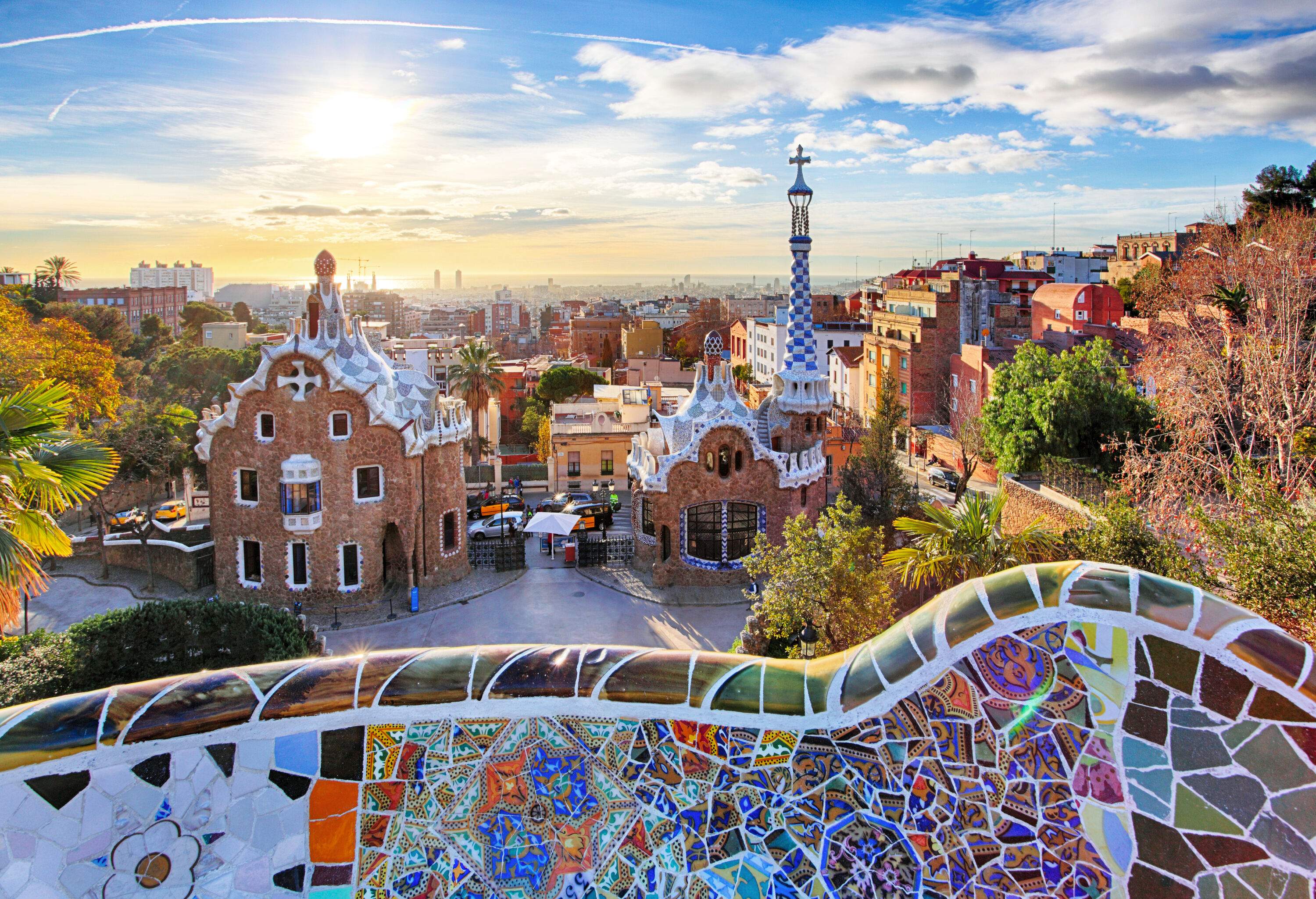 A rooftop terrace with a barrier made of colourful broken tiles overlooking the park's entrance.