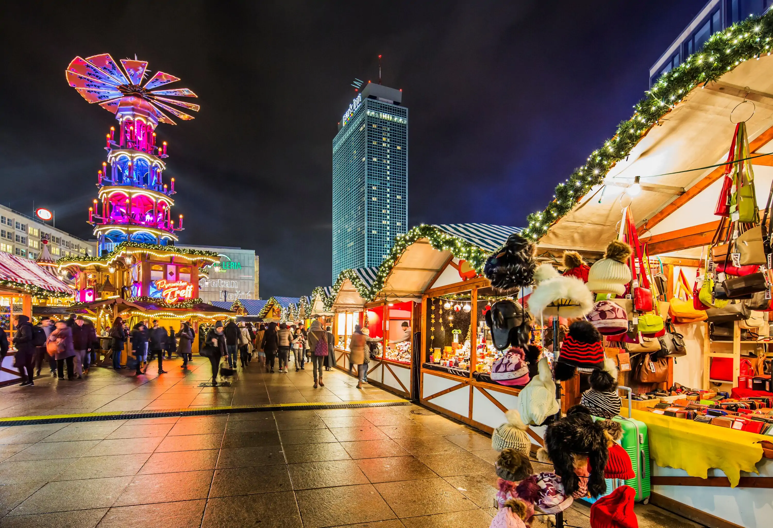 Alexanderplatz Christmas Market, on the background an illuminated tall hotel building