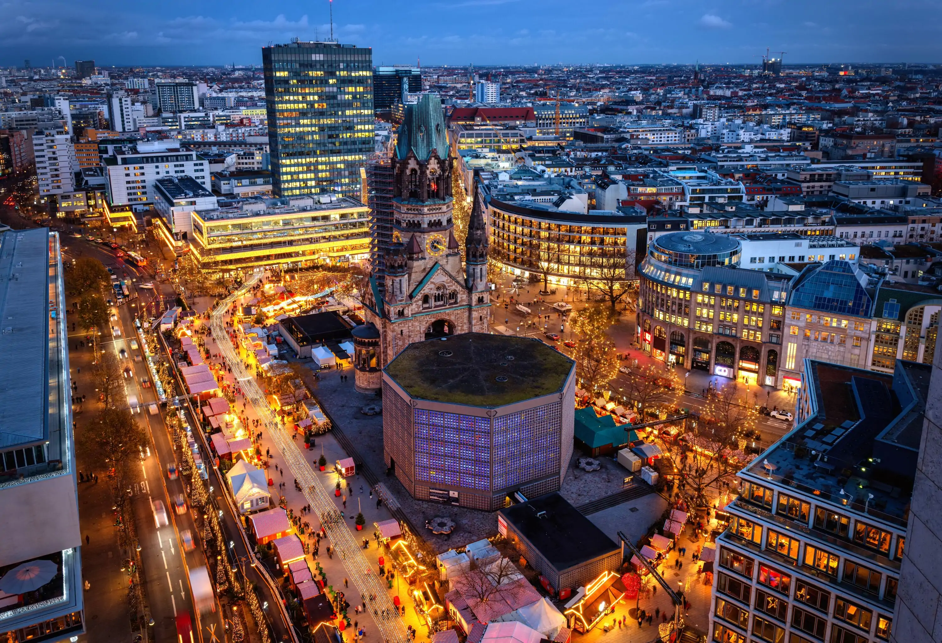 Elevated evening view of the City Center West skyline of Berlin, Germany, with Memorial Church and a christmas market during advent time