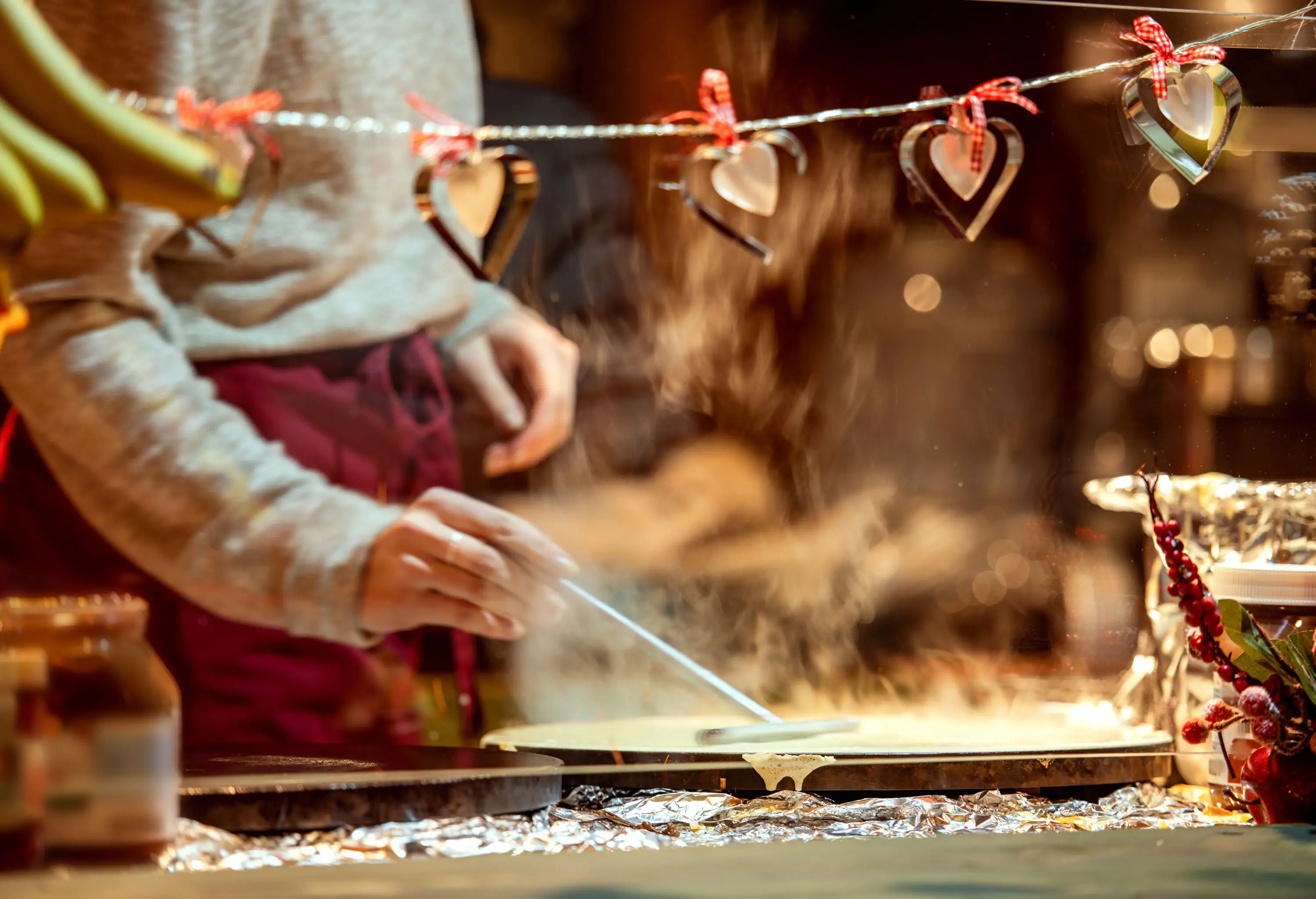 Close up of person preparing crepes pancakes at Christmas market