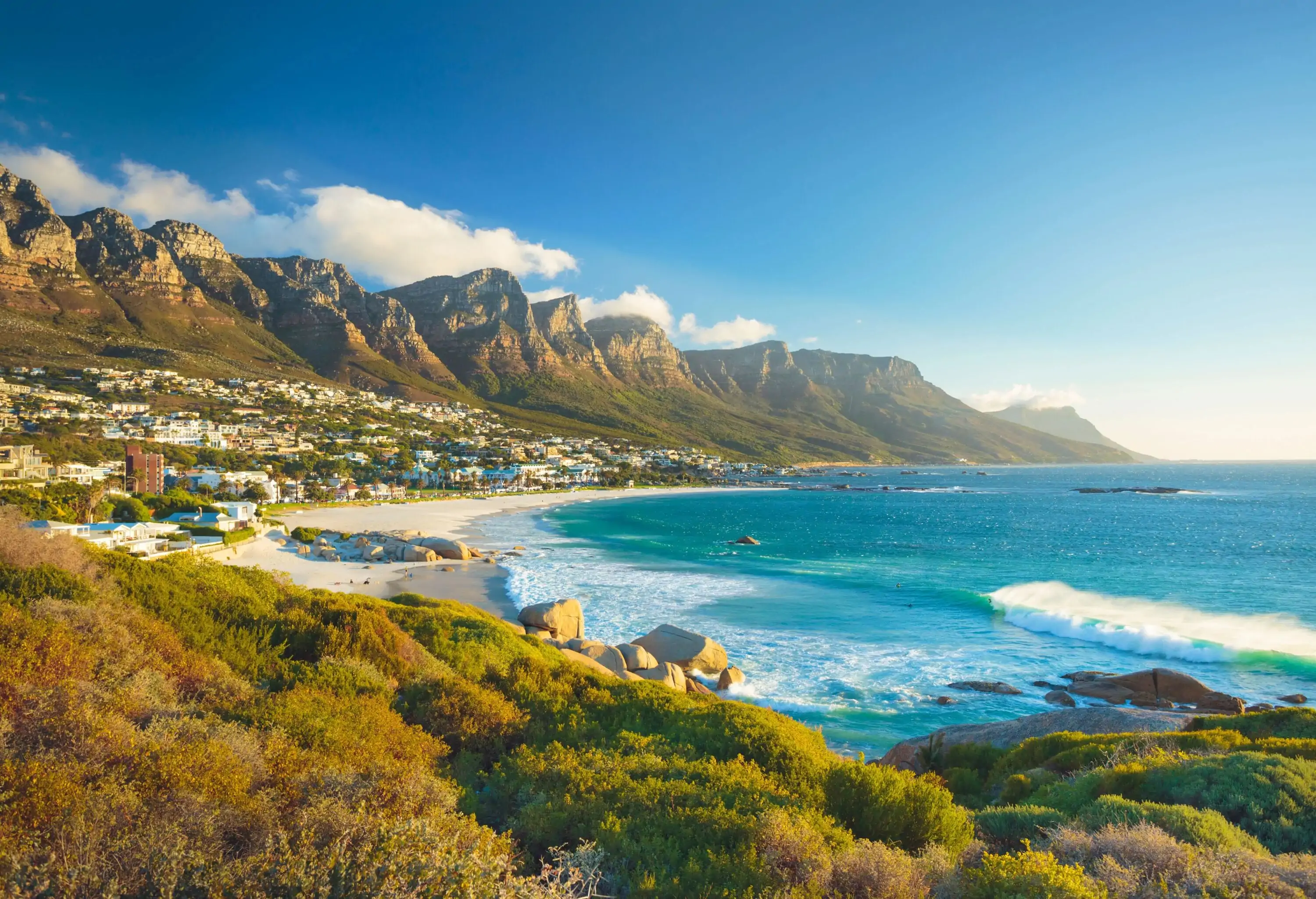 A beautiful beach bordered by a stunning mountain range.