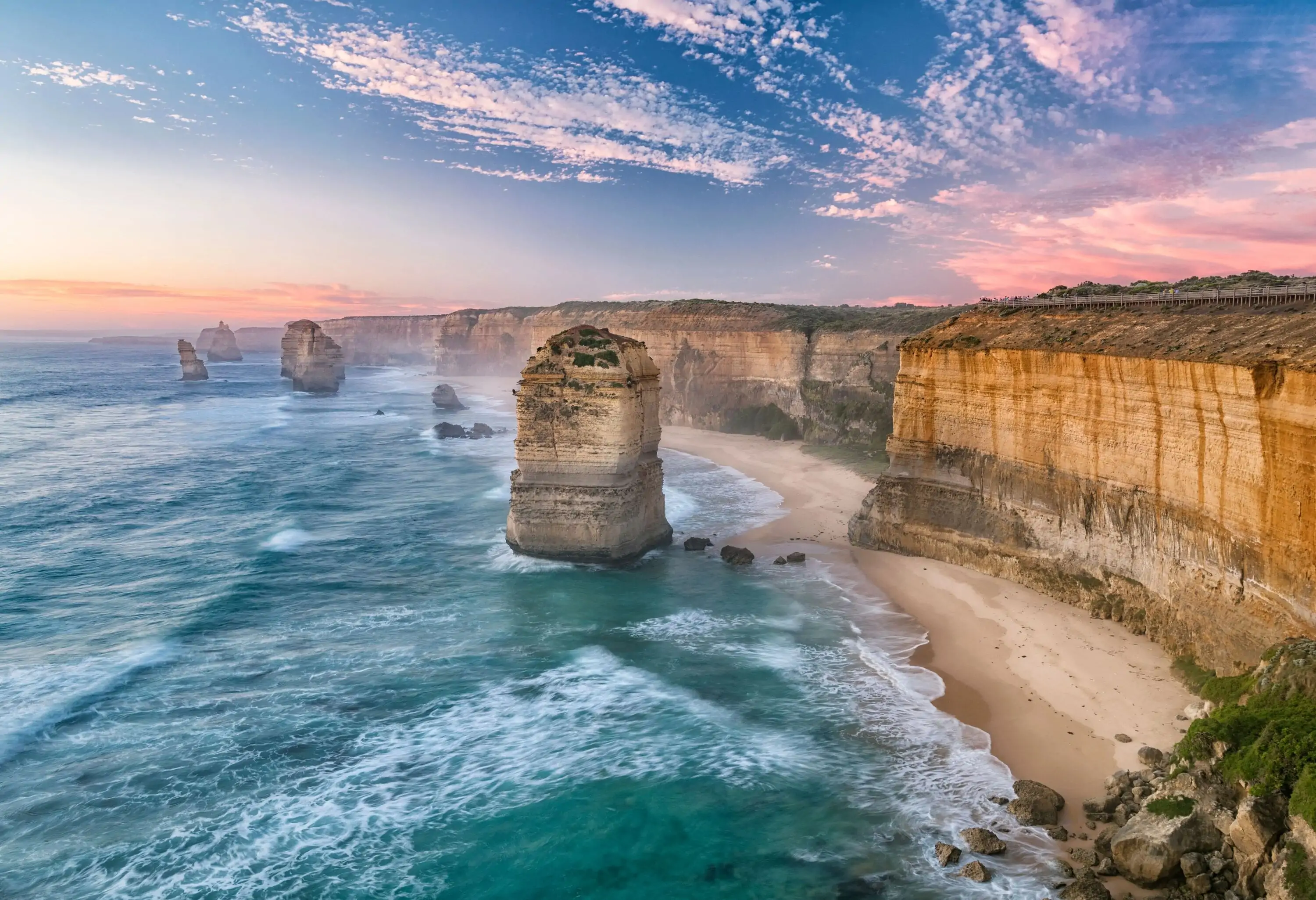 Vertical limestone stacks scattered over the water, backed by steep-sided cliffs.