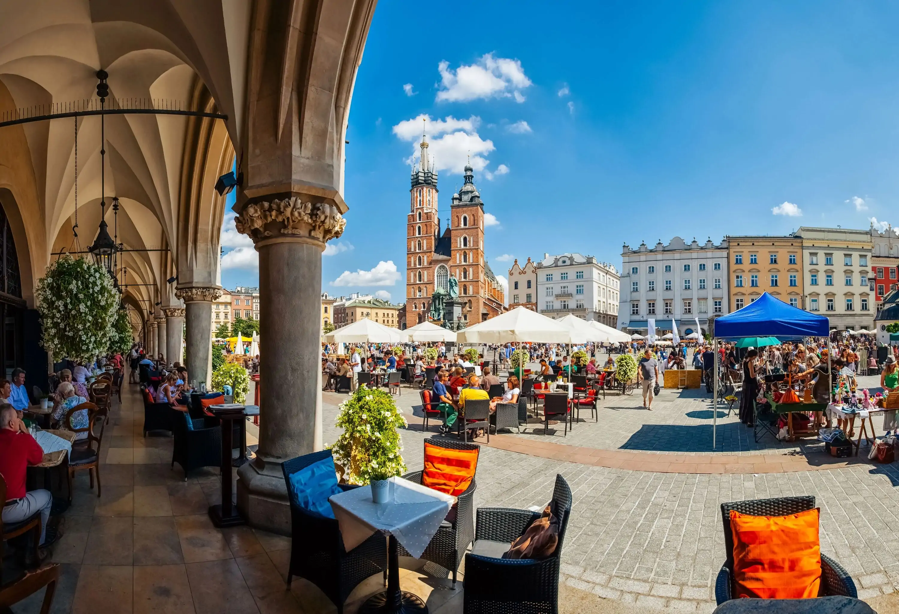 Krakow full of tourists having a coffee break under the archs of the Cloth Hall