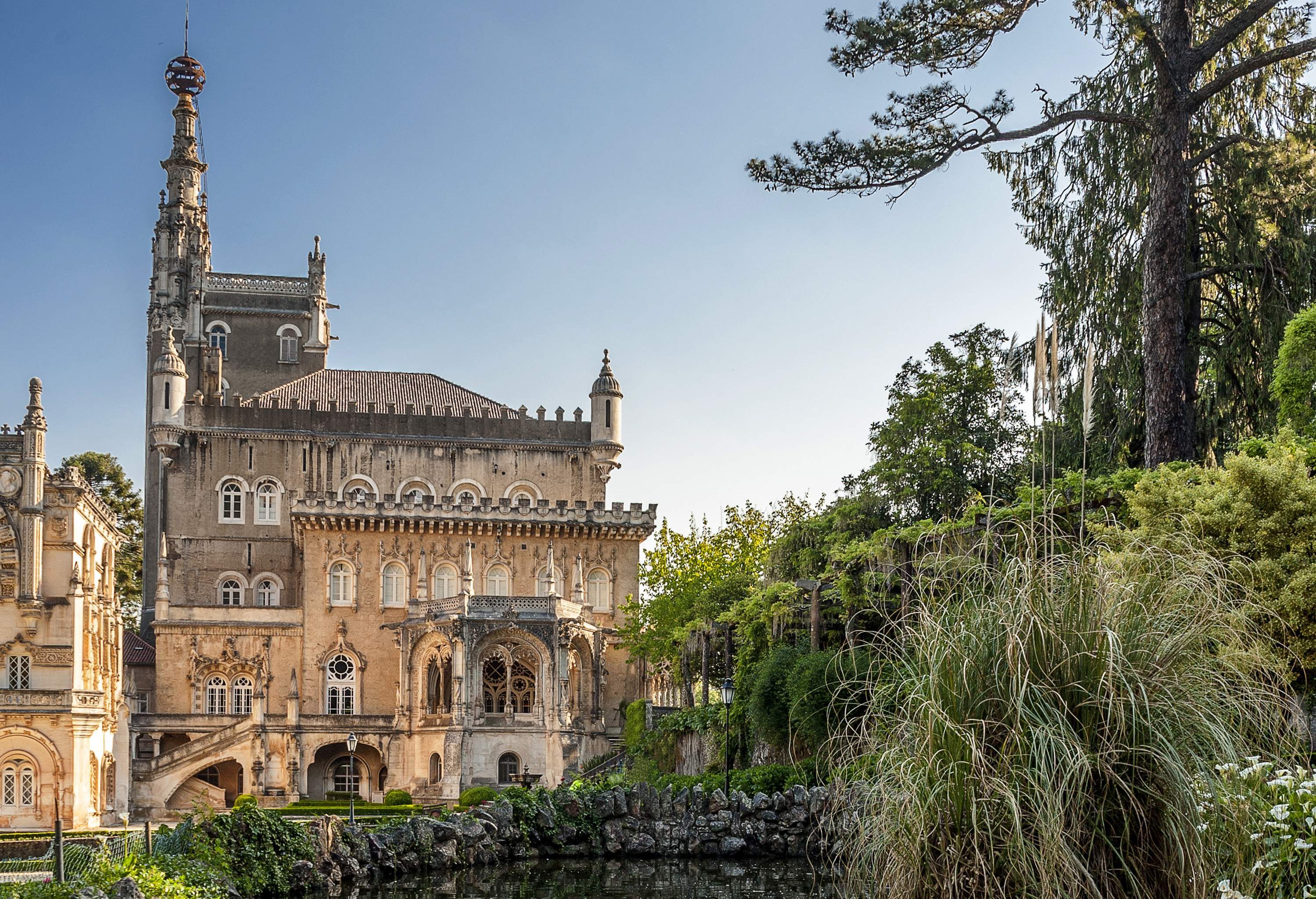 View of elaborate ancient palace surrounded by a large garden on a sunny day