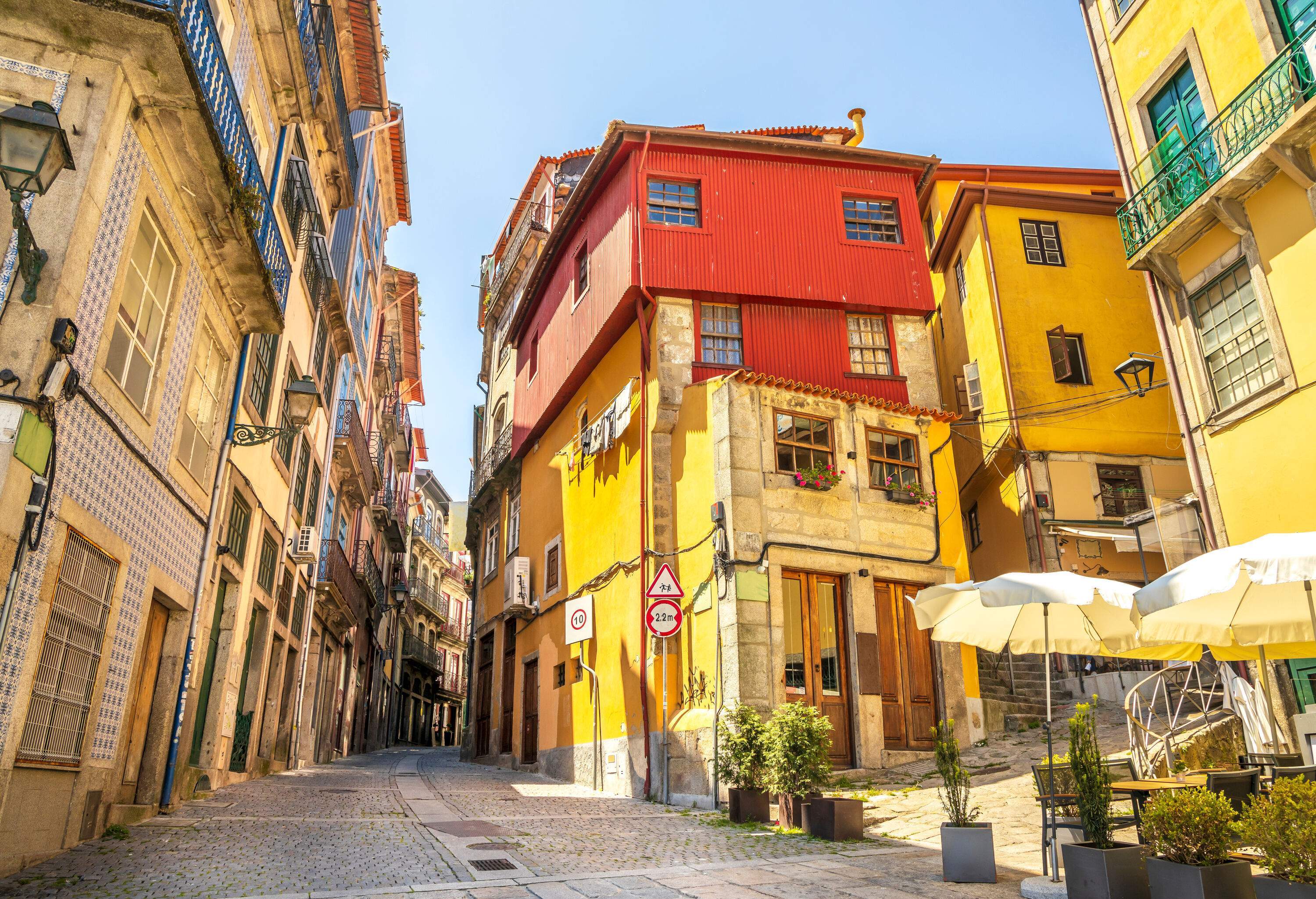 Charming traditional colourful houses line a quaint street.