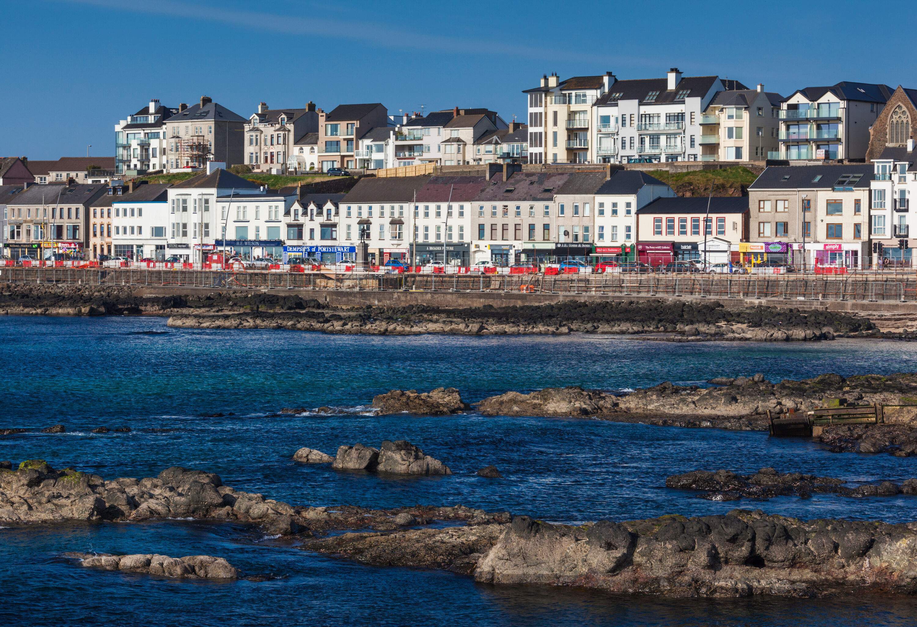 Two rows of beautiful houses layered on a seaside hill.