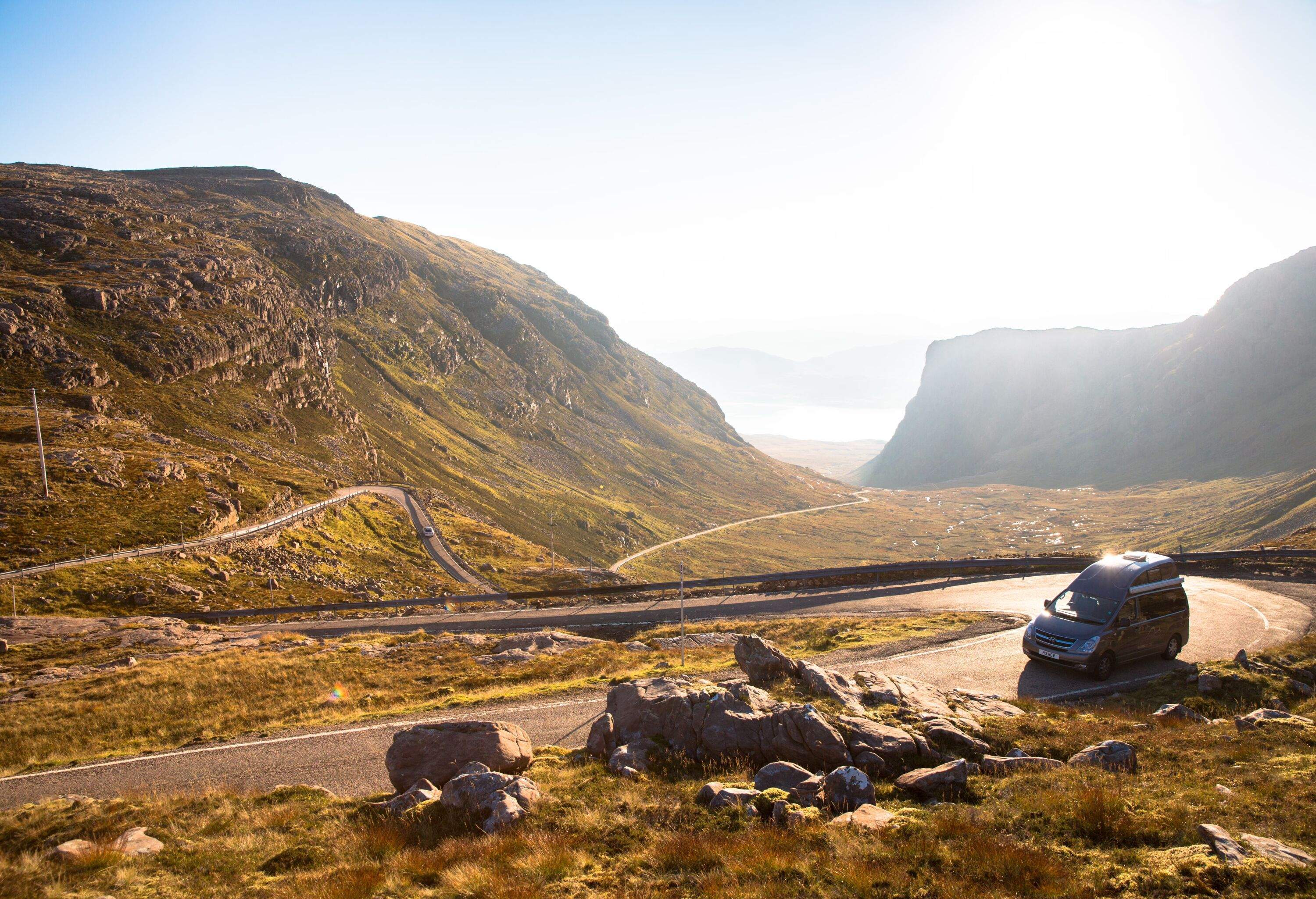 Campervan climbing Applecross pass, North West Scotland, UK