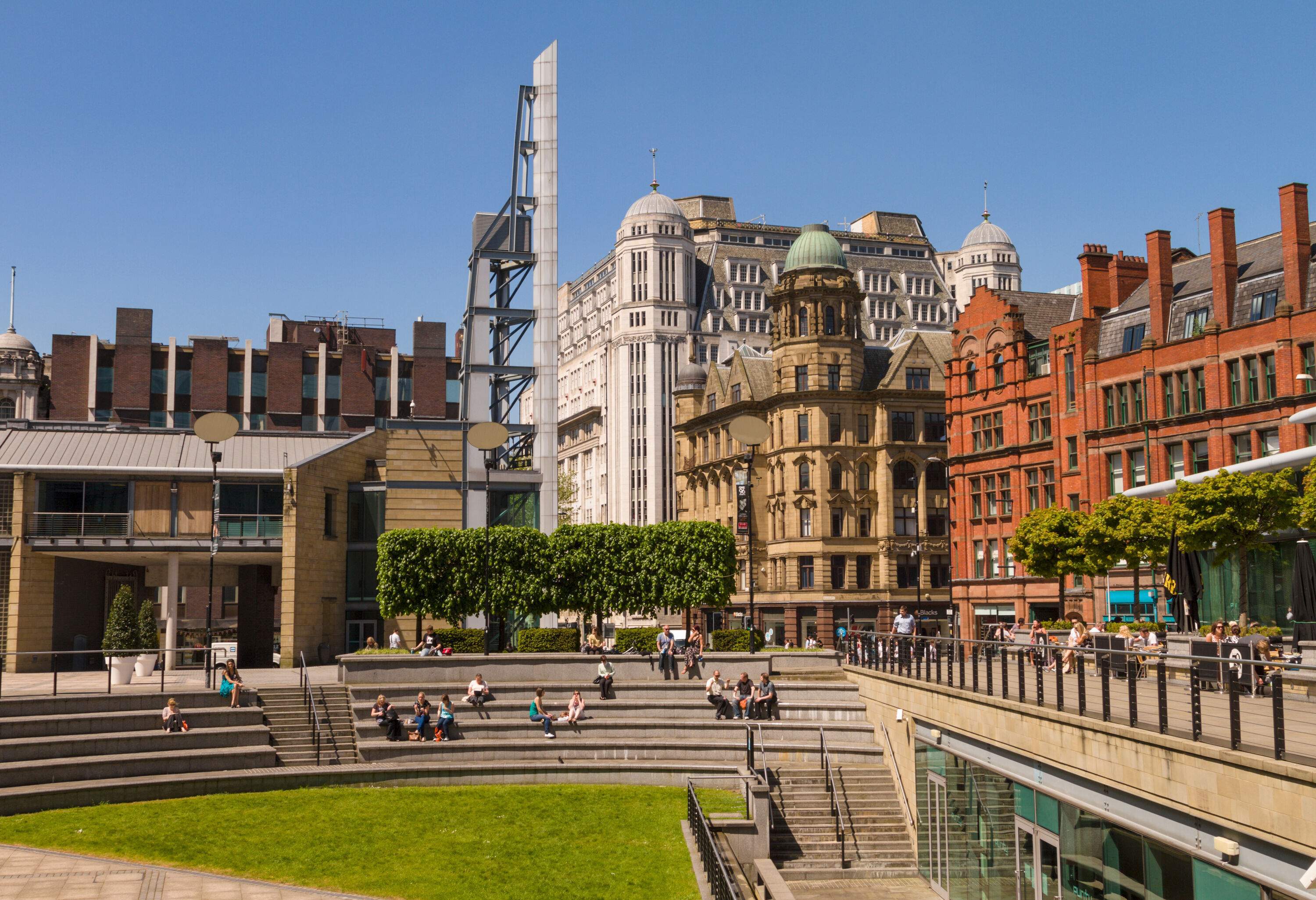 A section of Great Northern Square featuring a unique arrangement of stair-like benches, surrounded by tall buildings.