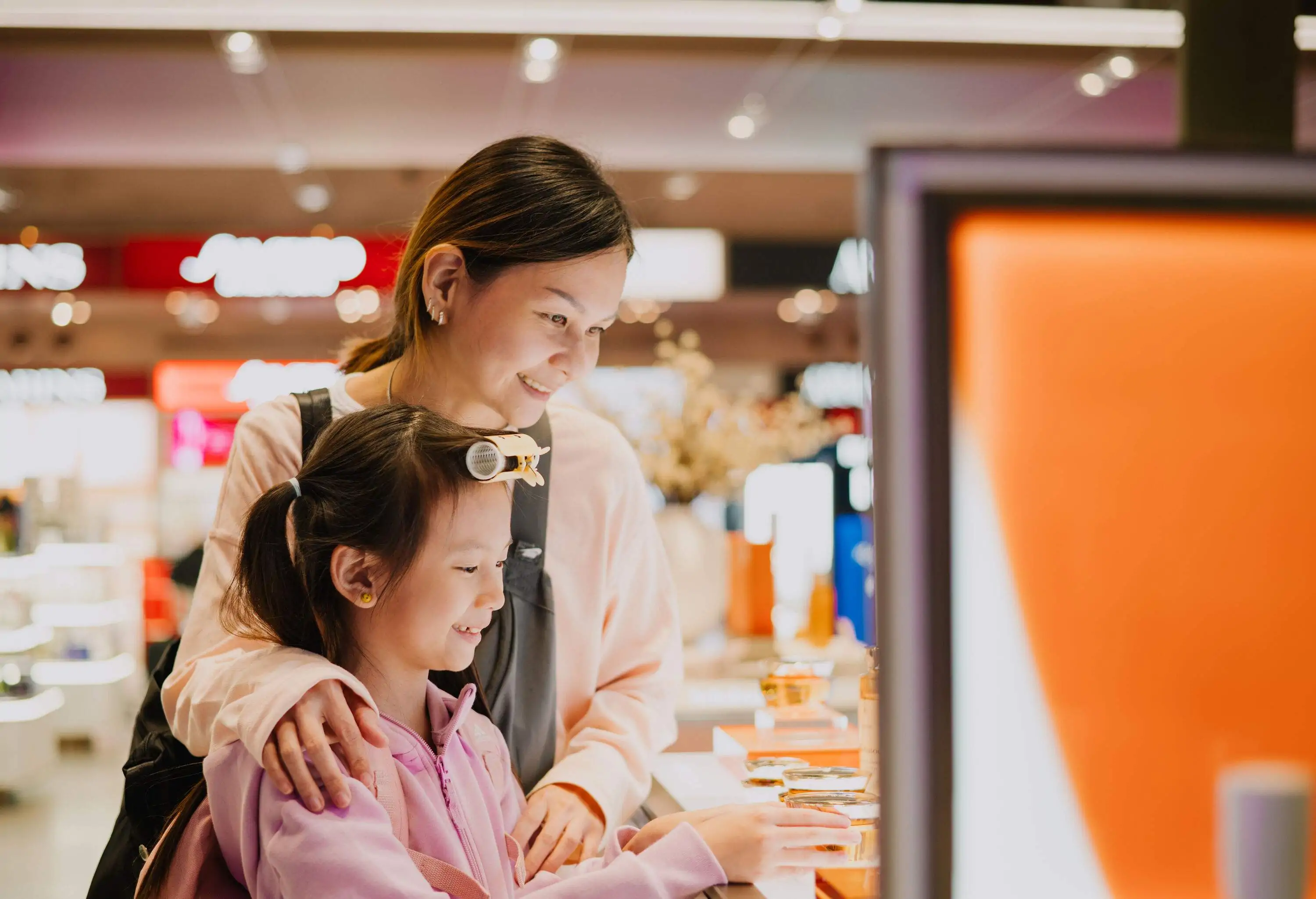 Asian Chinese Mother And Daughter Shopping In Airport