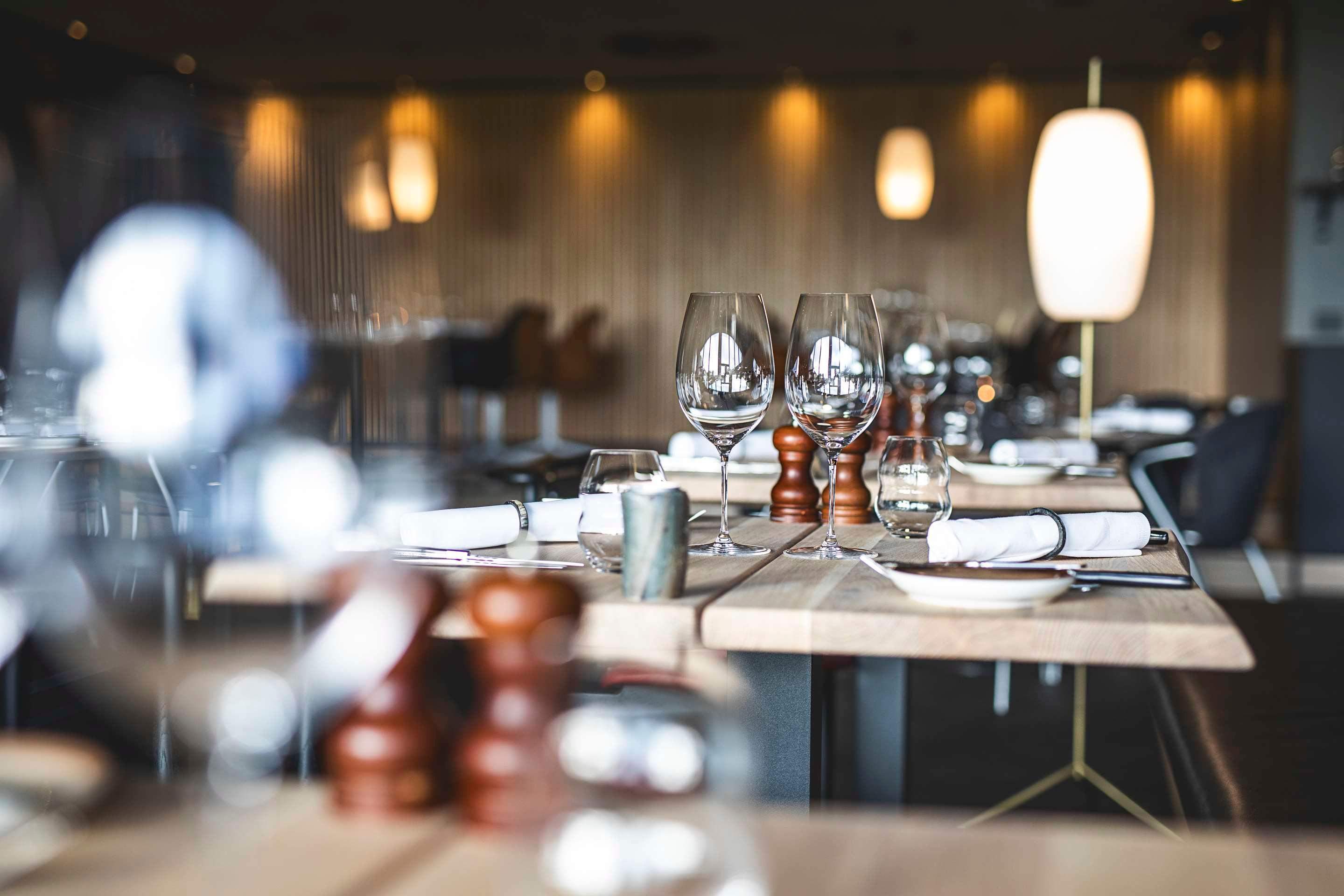 Table in a restaurant set for dinner in a modern yet rustic setting