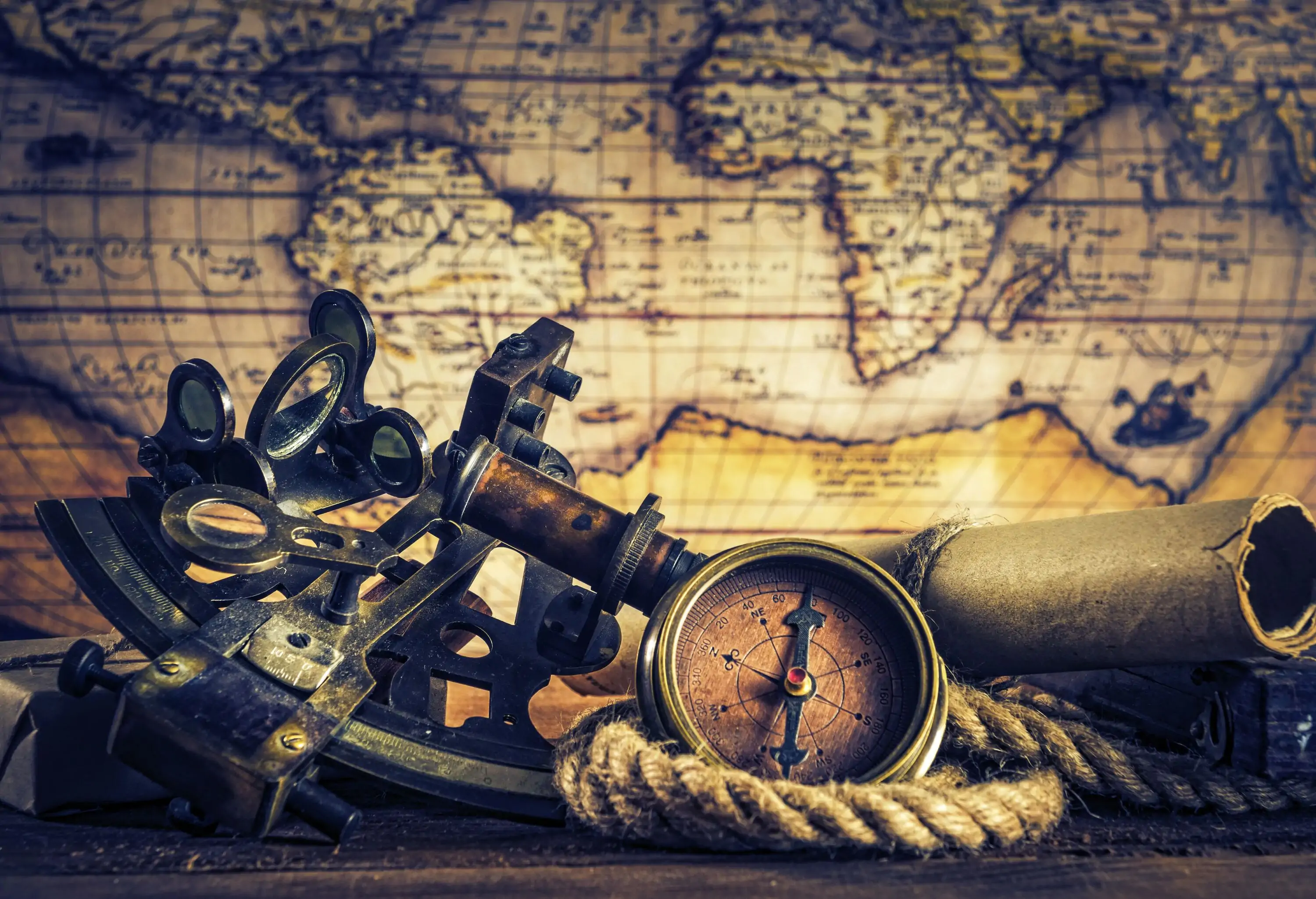 Vintage nautical equipment, including a sextant and a compass, against a world map.