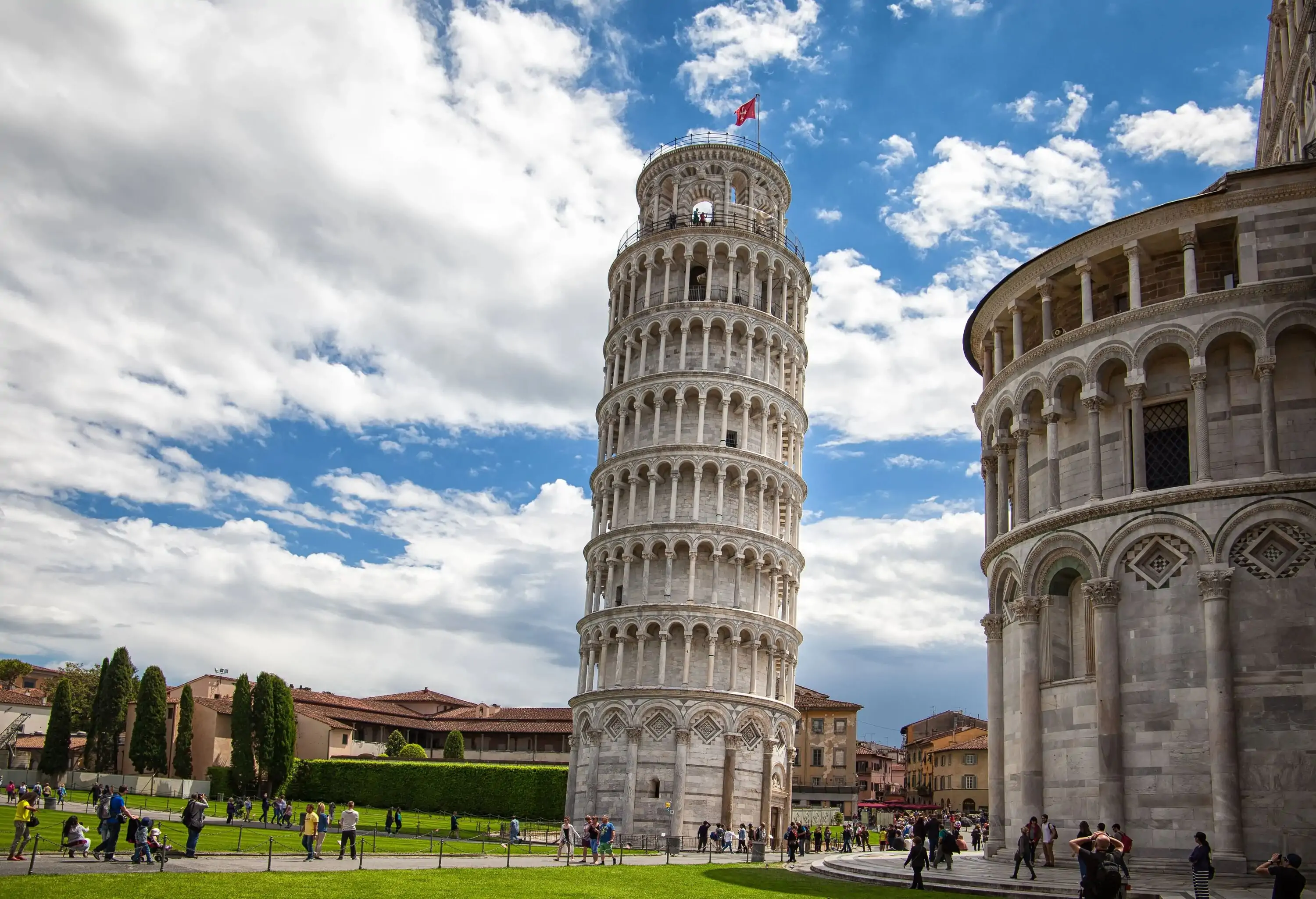 The Leaning Tower of Pisa is a tilted freestanding bell tower designed with marble arches and columns.