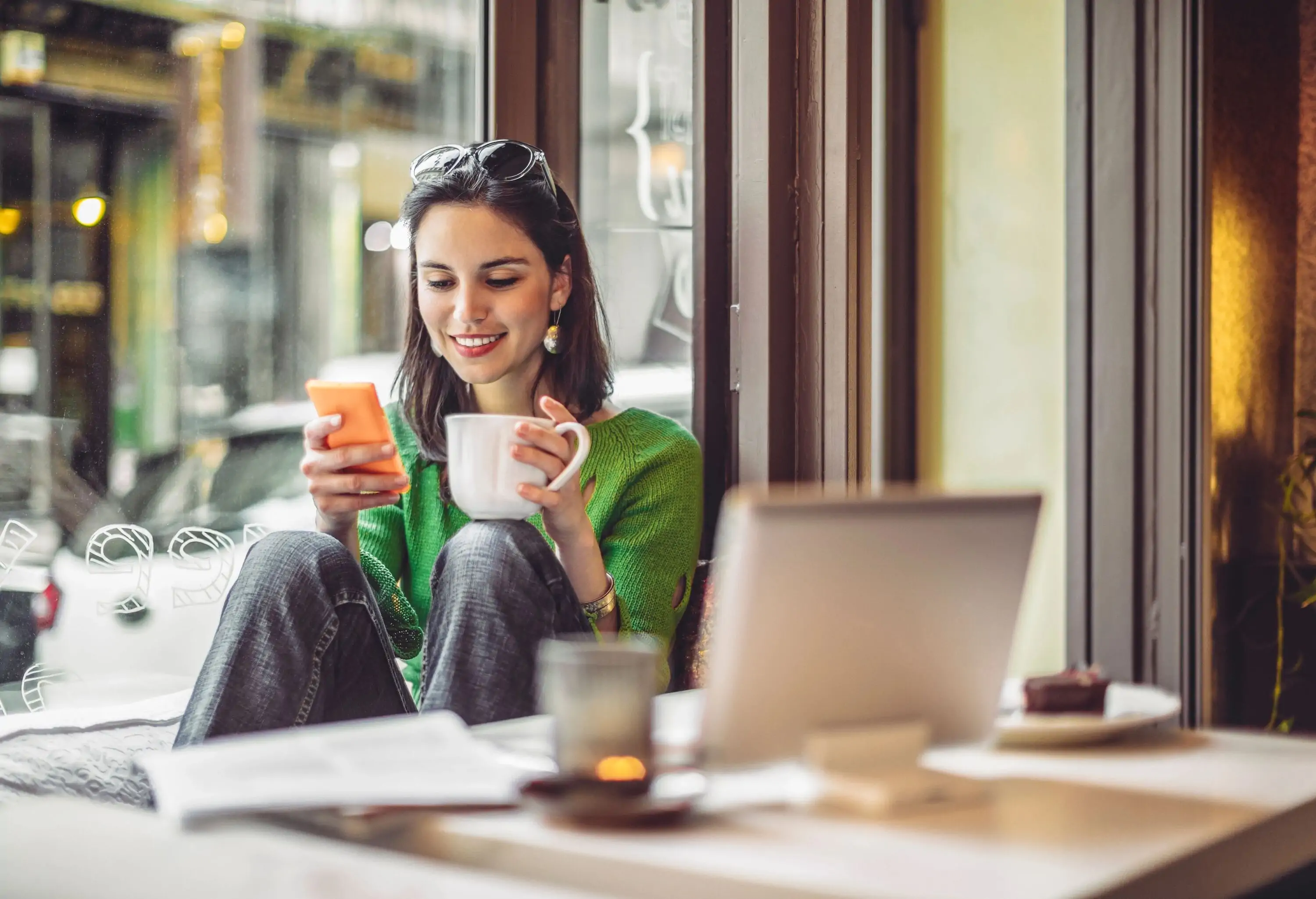 Young woman enjoying a cup of coffee on a rainy day