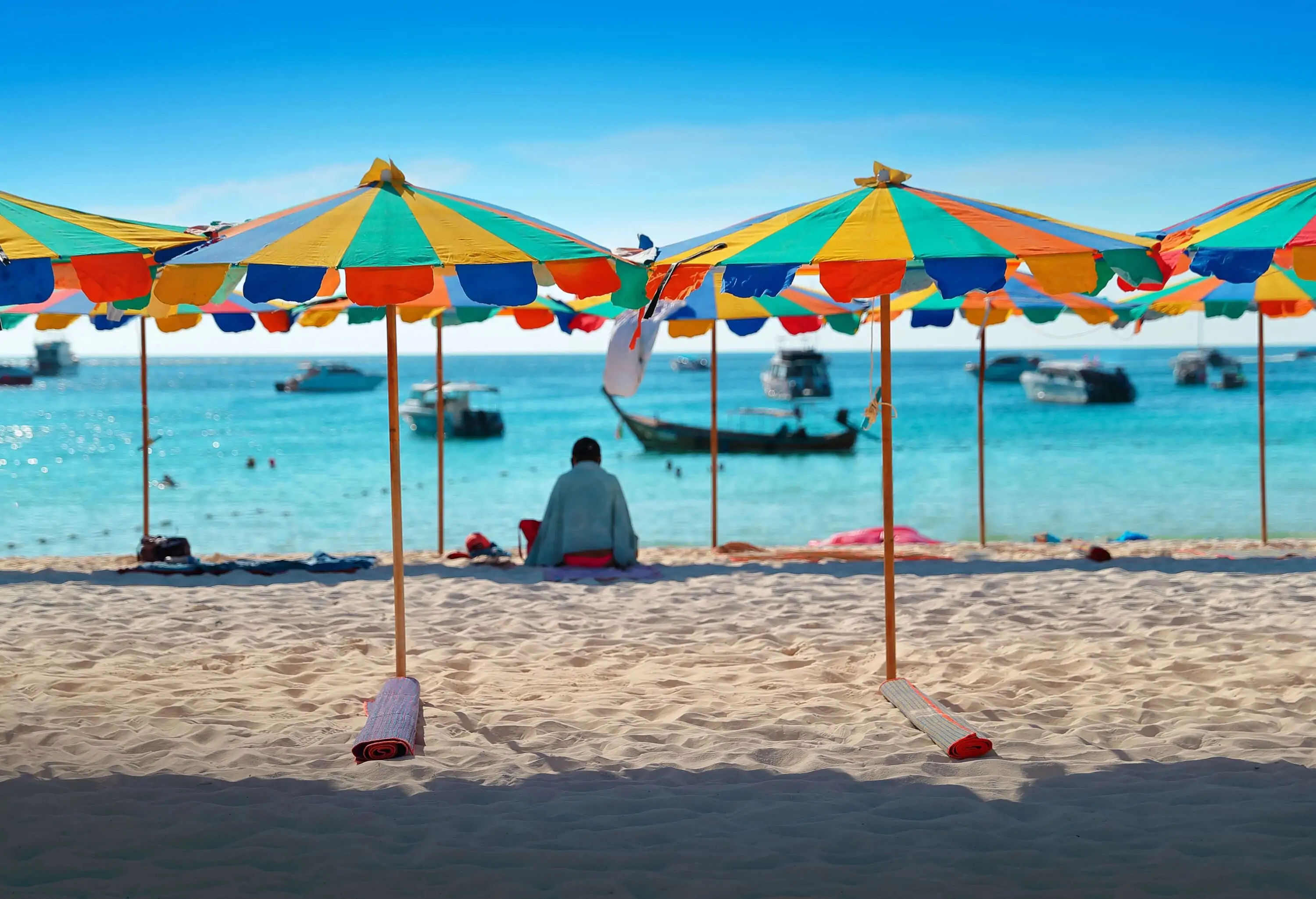 Colourful striped parasols on a tropica beach