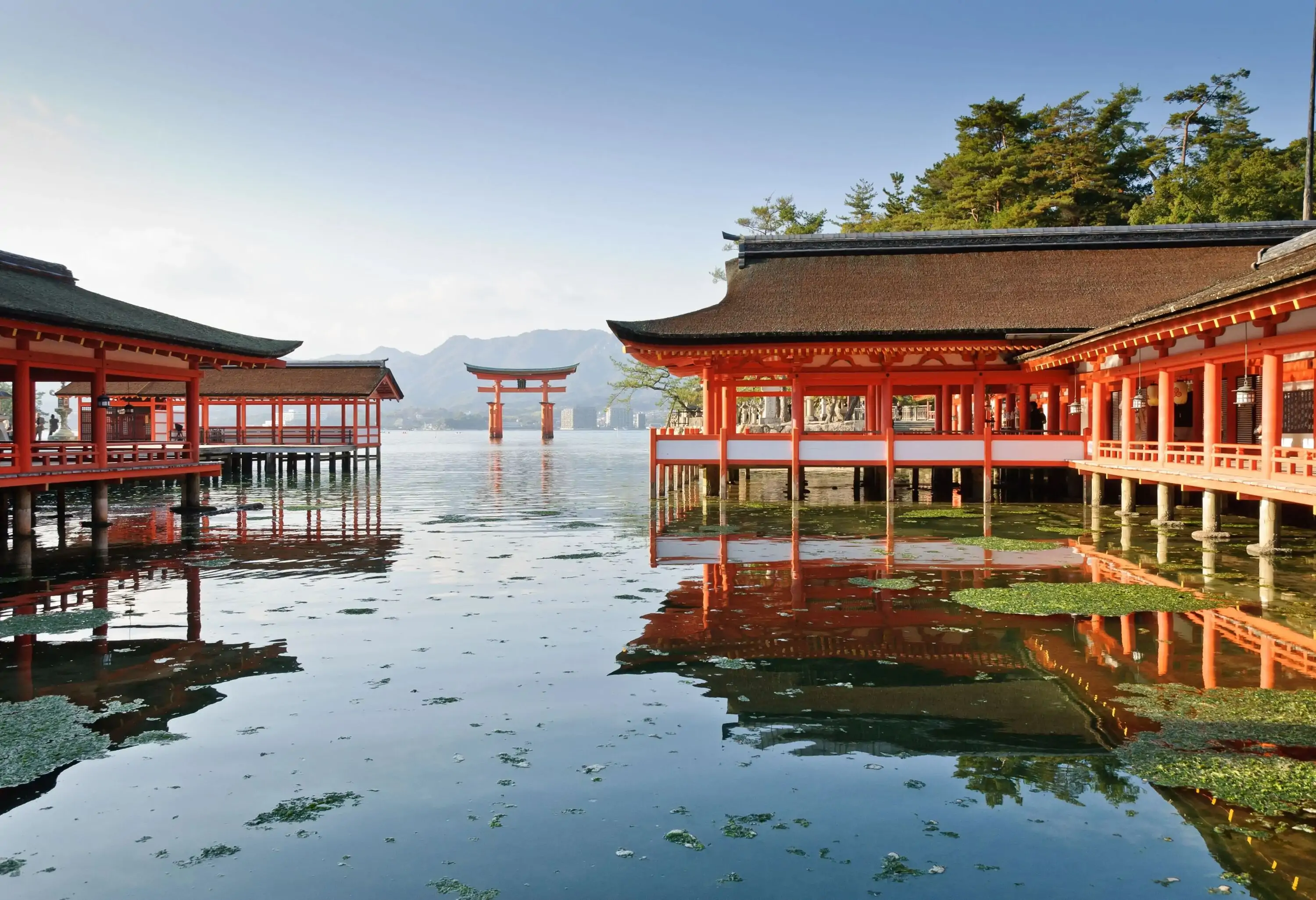 A red wooden shrine over a body of water