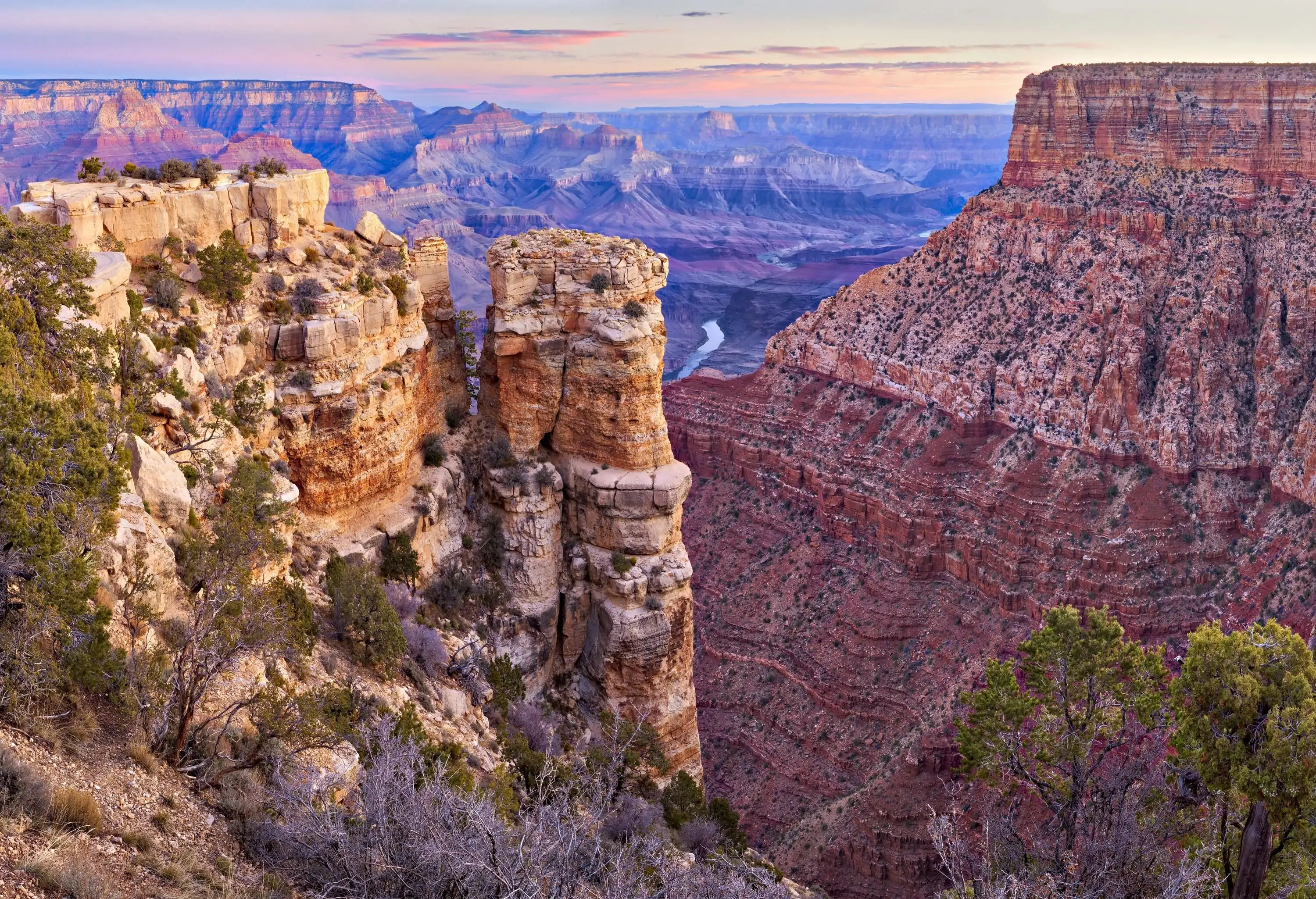 A magical landscape of an immense steep canyon with exposed layers of colourful rocks that are absolutely mesmerising.