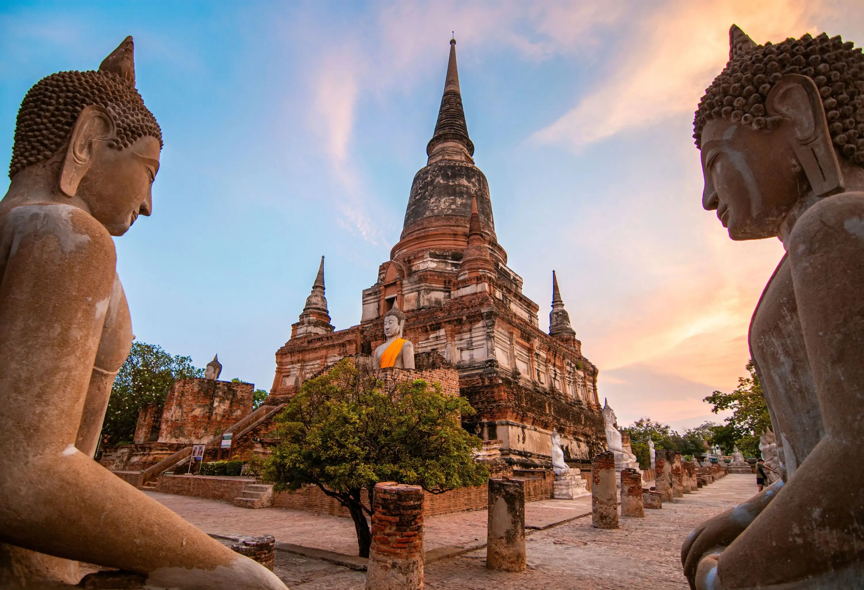 buddha statue with a tall chedi in the center of Wat Yai Chaya Mongkol in Ayutthaya Thailand. It is one of the famous landmark to see in this ancient city.