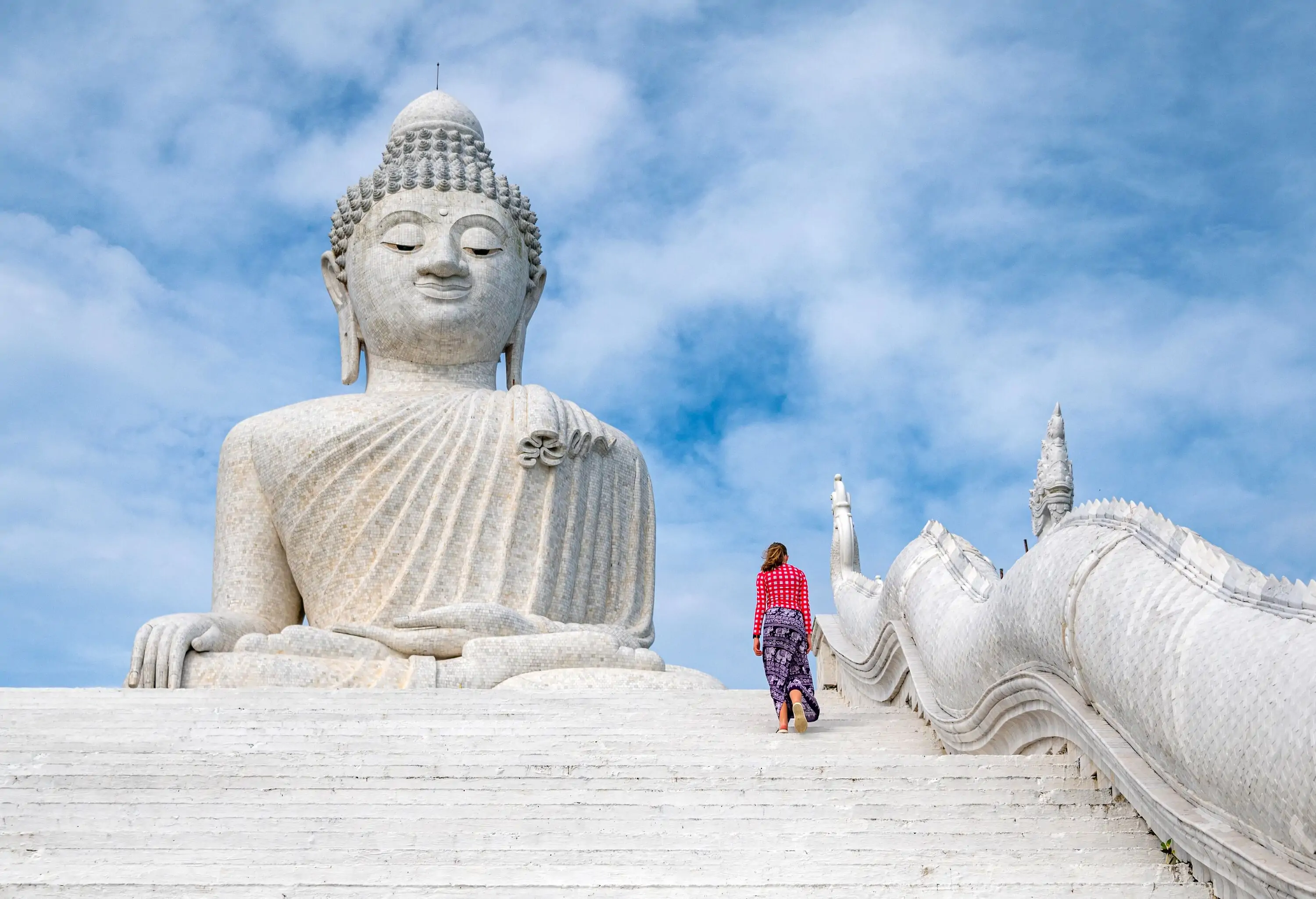 Woman climbing the stairs to White marble statue of Big Buddha in Phuket,Thailand